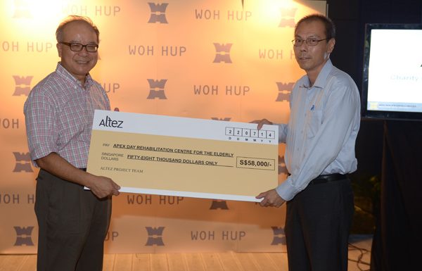 2 men holding a big check